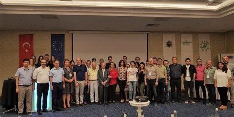 Project participants posing in front of Turkish and EU flags