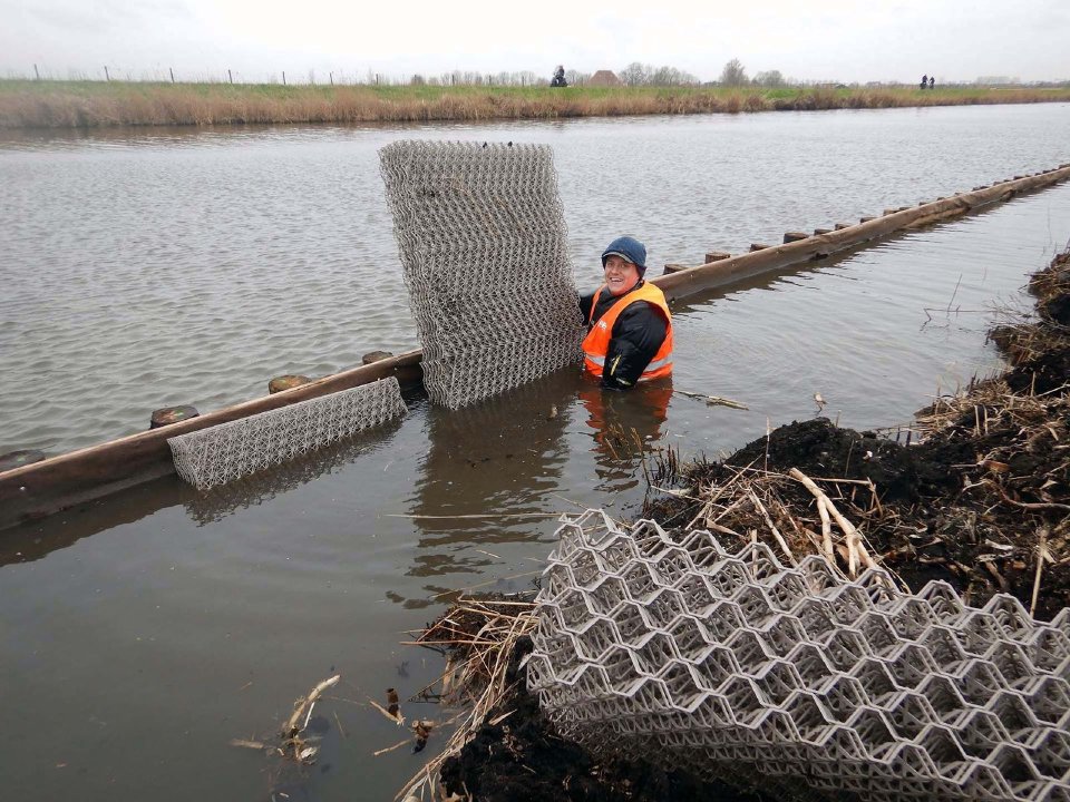 Installing biodegradable restoration structures in a canal bank